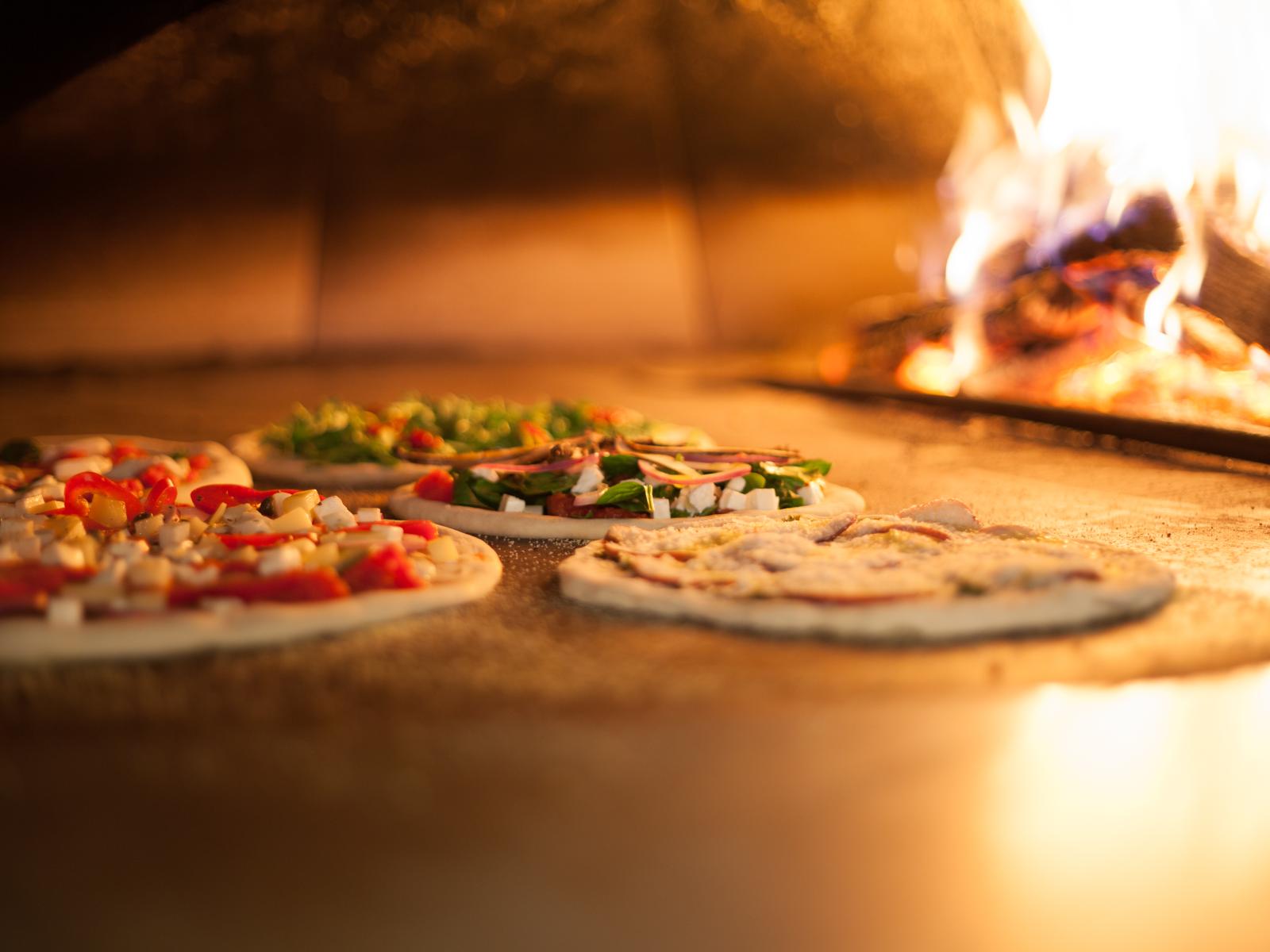 Pizzas Cooking in the Wood Fired Oven