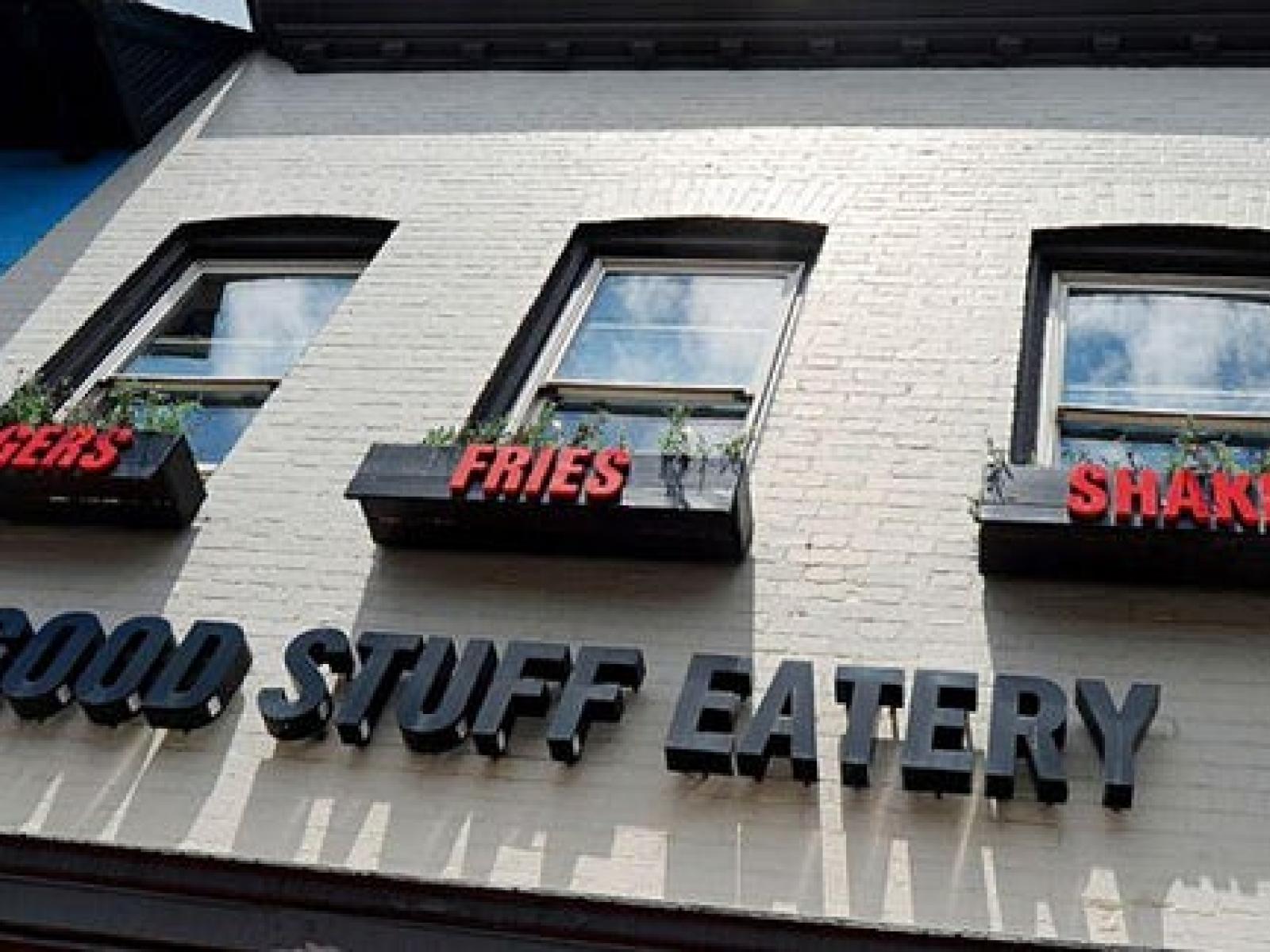 Outside of Good Stuff Eatery building in Georgetown with black lettering on white brick and windows